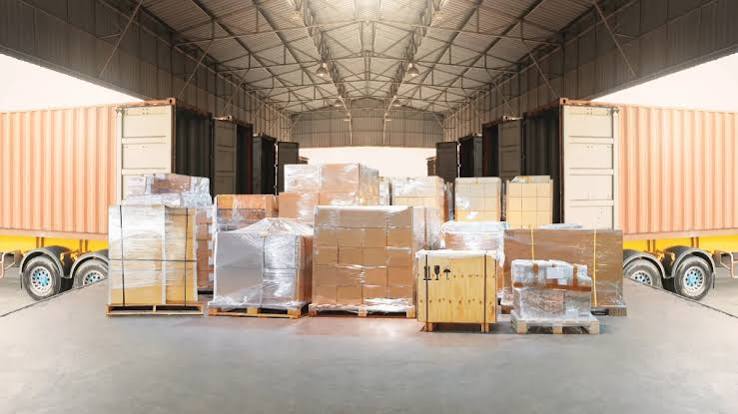 Palletized freight staged between trailers for commercial delivery